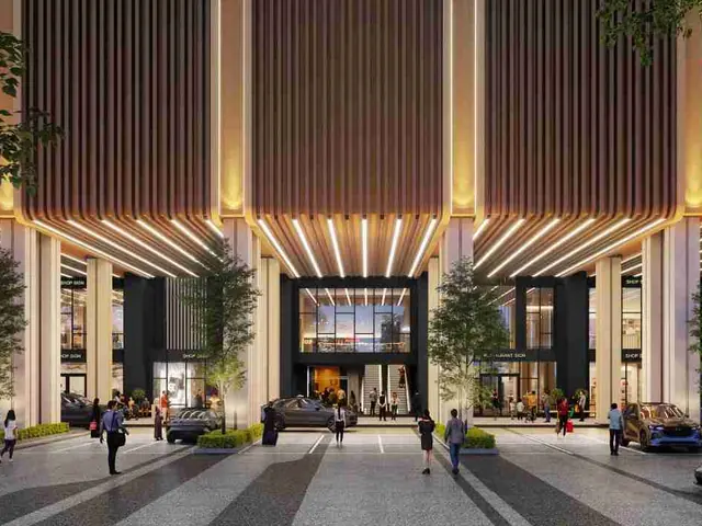 Retail podium entrance with shops and restaurants at night