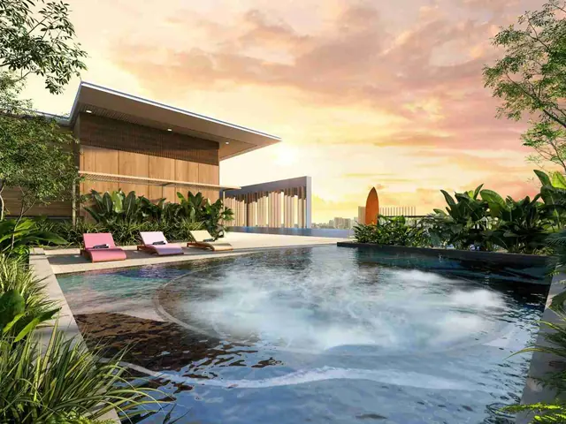 Rooftop infinity jacuzzi at sunset with sun loungers and city views