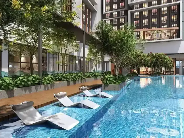 Swimming pool with in-water loungers and a landscaped deck